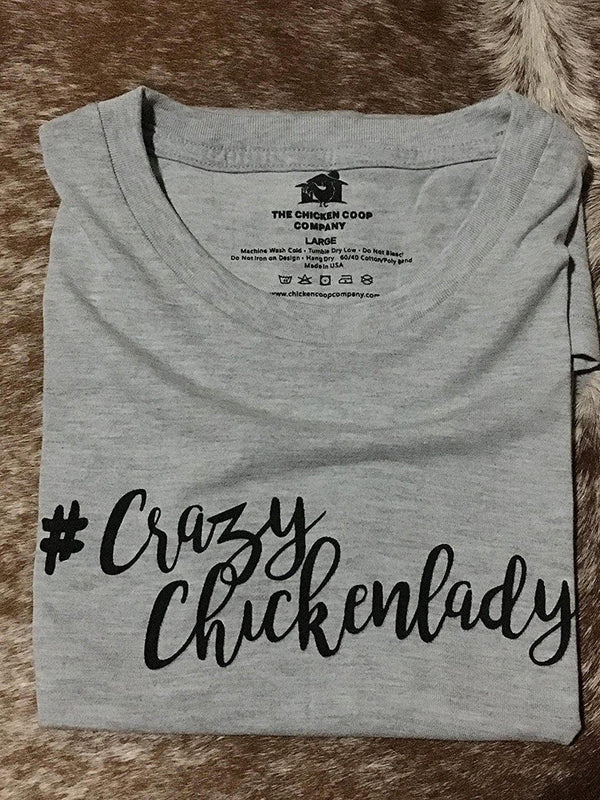 A grey t-shirt with the text "#CrazyChickenlady" printed in black, ideal for women who love chickens.